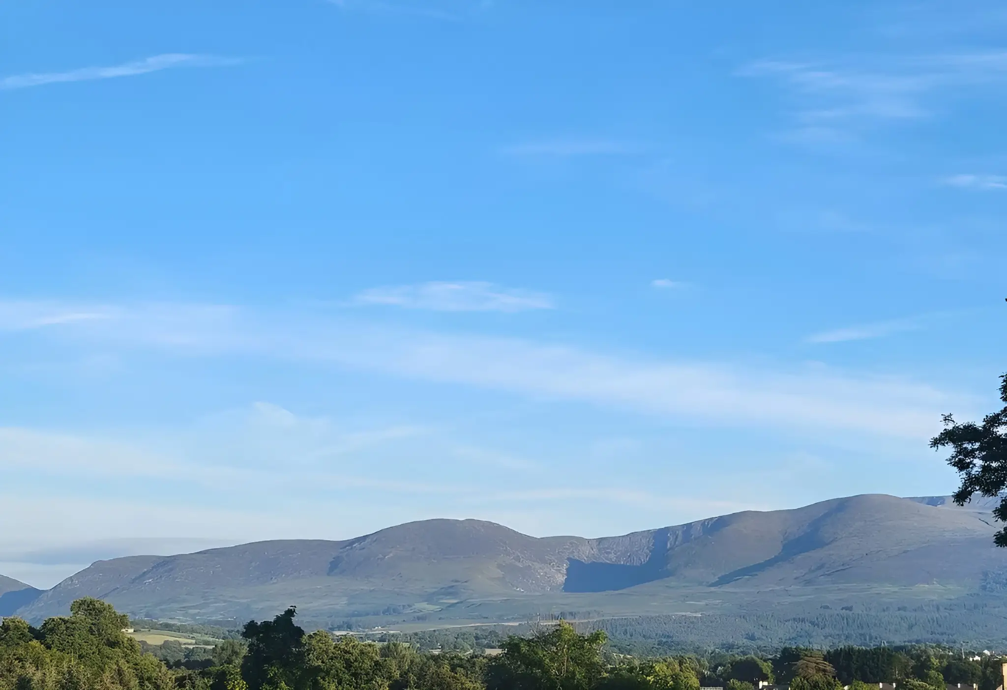 The view in front of Nead Neamhaí of the mountains surrounding Killarney